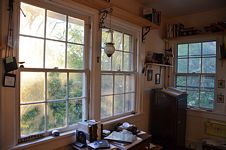 Angled shot across chest toward dictionary stand in front of windows.